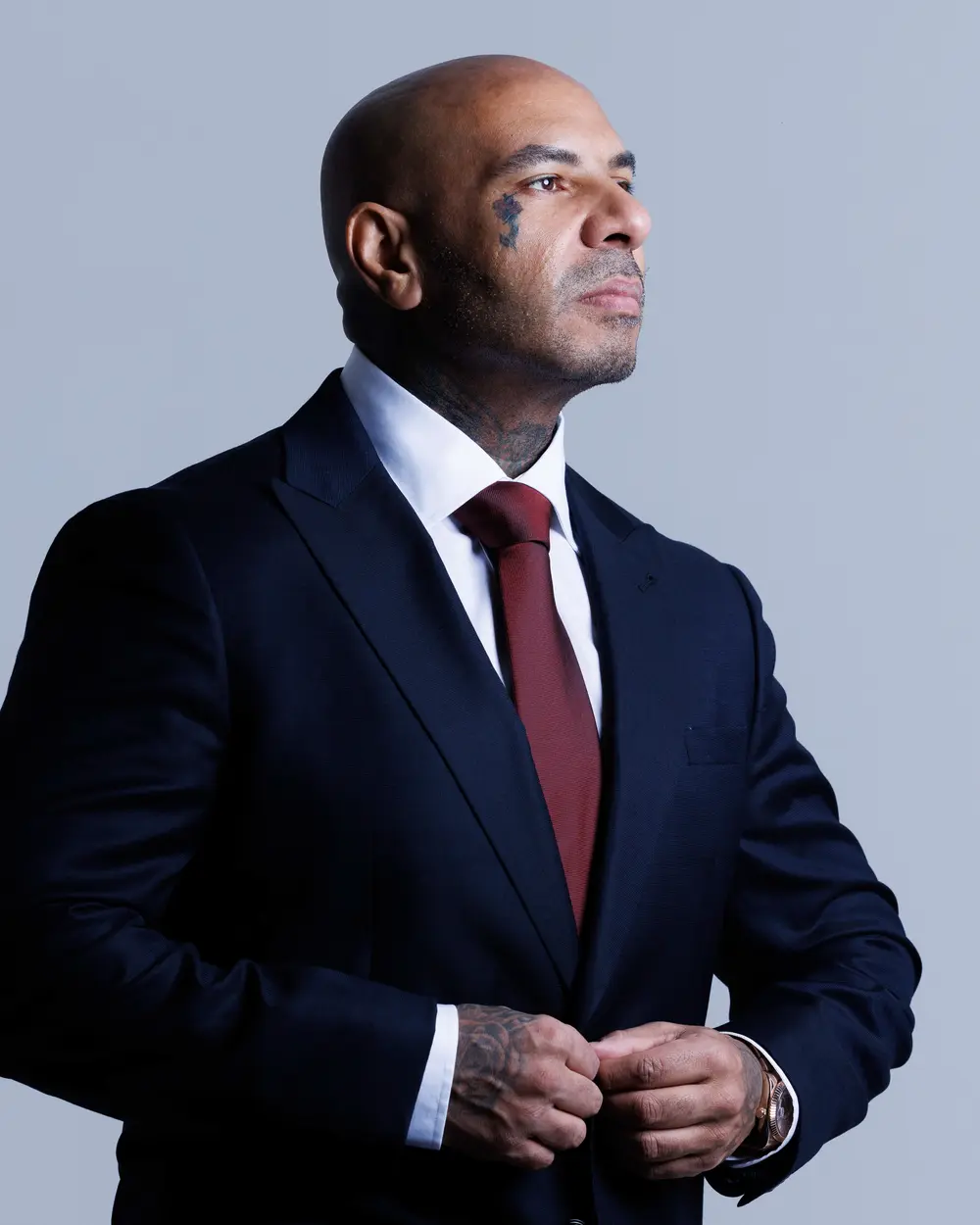 Karim Gharbi, founder of K2 Meta, in a dark suit against a grey studio background